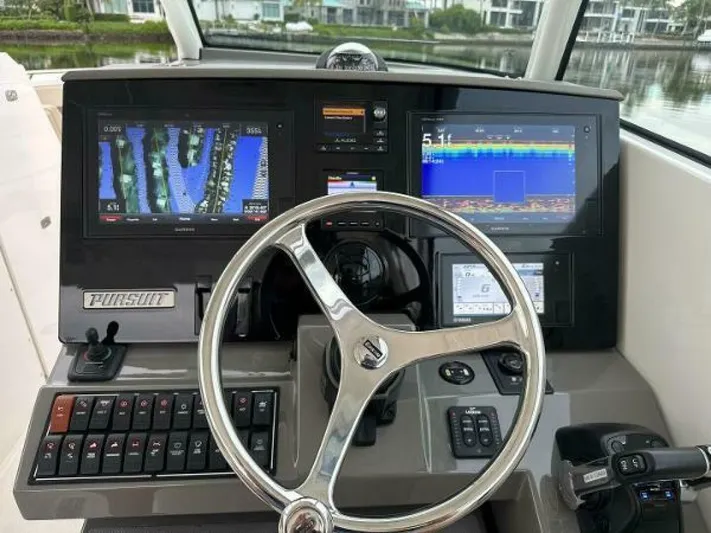  Yacht Photos Pics 2019 Pursuit DC 325 Dual Console dashboard with navigation screens and steering wheel.