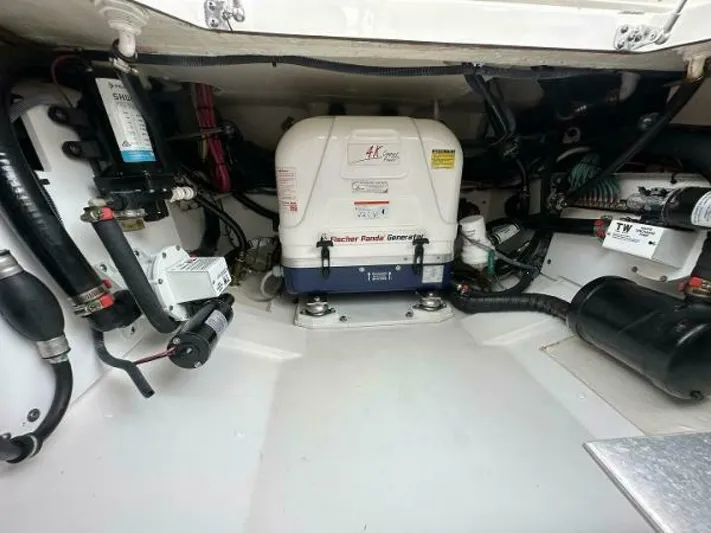 Yacht Photos Pics Engine compartment of a 2019 Pursuit DC 325 Dual Console boat, featuring a Fischer Panda generator.