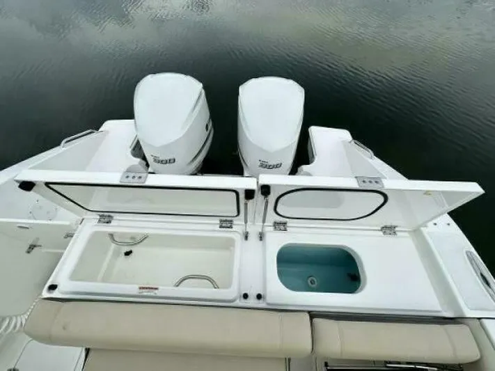  Yacht Photos Pics 2019 Pursuit DC 325 Dual Console boat with open storage compartments and twin engines.