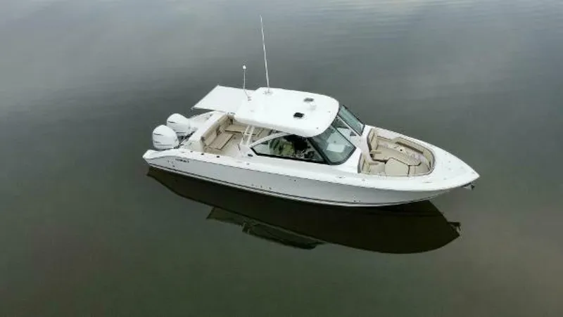  Yacht Photos Pics 2019 Pursuit DC 325 Dual Console boat on calm water, aerial view.
