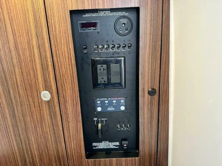  Yacht Photos Pics Control panel of 2019 Pursuit DC 325 Dual Console boat, featuring switches and outlets.