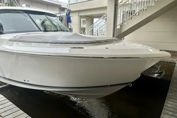  Yacht Photos Pics 2019 Pursuit DC 325 Dual Console boat docked near modern building.