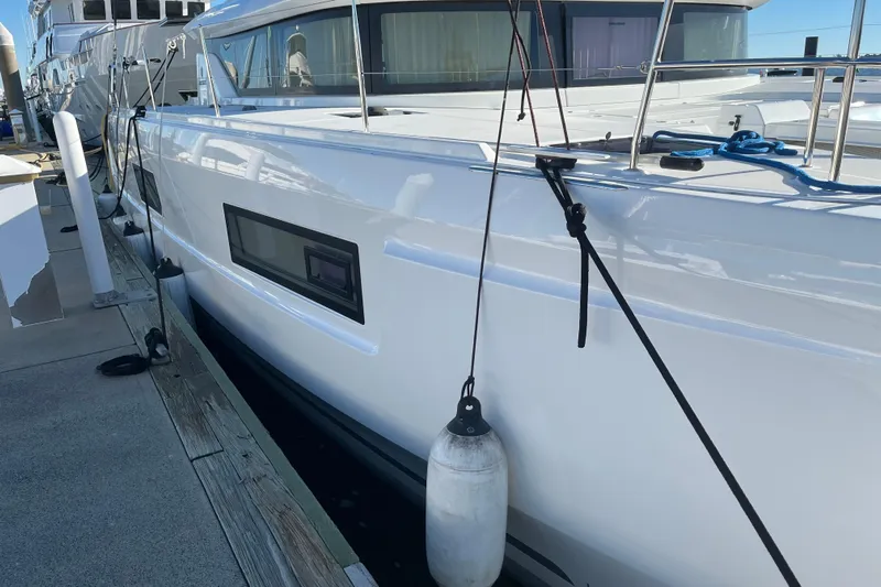 Exodus Yacht Photos Pics 2022 Lagoon 46 catamaran docked at marina, showcasing sleek design and modern features.