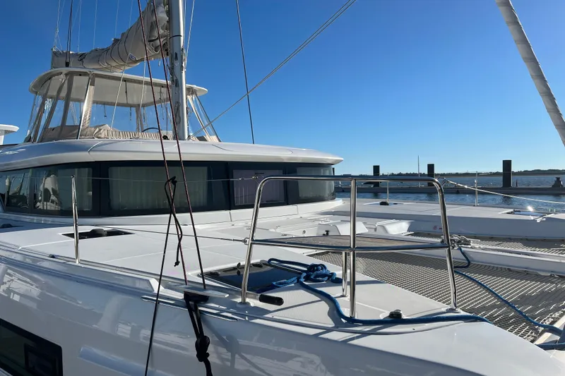 Exodus Yacht Photos Pics 2022 Lagoon 46 catamaran docked, featuring sleek design and spacious deck.