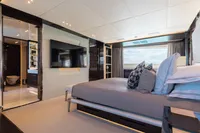 Luxurious bedroom interior on 2016 Benetti Custom Built yacht with modern decor and ocean view.