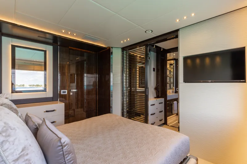 Domani Yacht Photos Pics Luxurious bedroom interior on 2016 Benetti Custom Built yacht, featuring modern design and elegant furnishings.