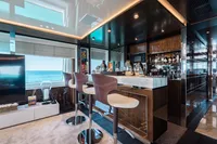 Luxurious yacht interior with modern bar, ocean view; Benetti Custom Built, 2016.