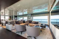 Luxurious interior of 2016 Benetti Custom Built yacht with elegant seating and ocean view.