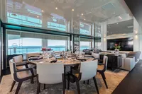 Luxurious dining area on 2016 Benetti Custom Built yacht with ocean view.