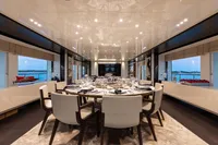 Luxurious dining area on a 2016 Benetti Custom Built yacht, featuring elegant table settings.