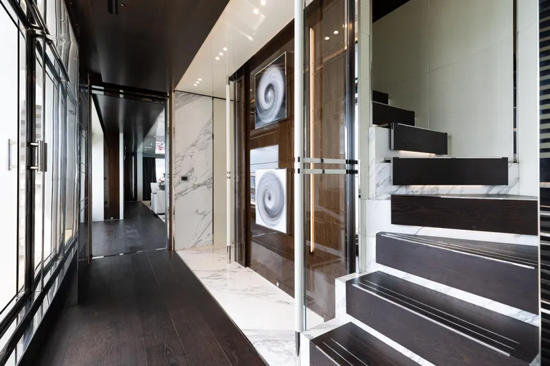 Domani Yacht Photos Pics Luxurious interior of 2016 Benetti Custom Built yacht with modern staircase and elegant decor.