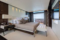 Luxurious bedroom on 2016 Benetti Custom Built yacht with elegant decor and ocean view.
