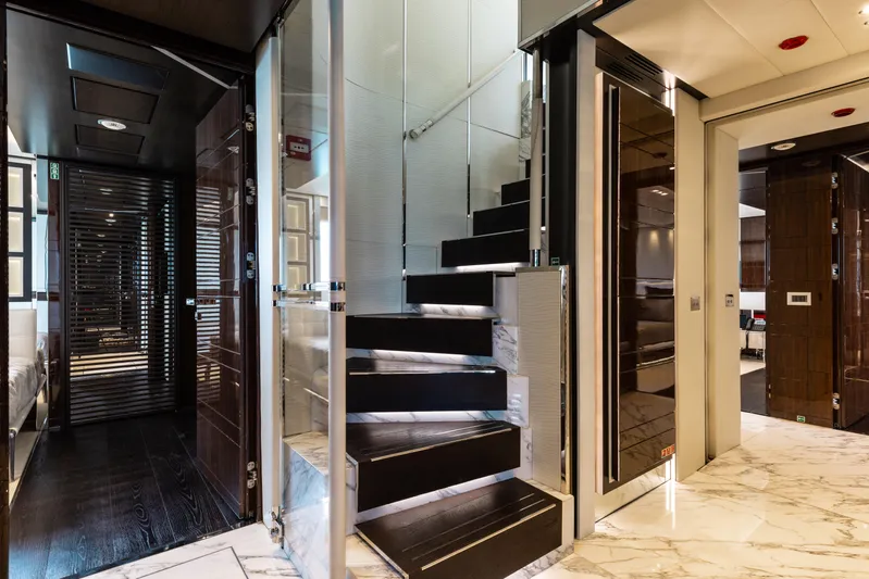 Domani Yacht Photos Pics Luxurious interior of 2016 Benetti Custom Built yacht with modern staircase and elegant design.