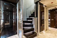 Luxurious interior of 2016 Benetti Custom Built yacht with modern staircase and elegant design.