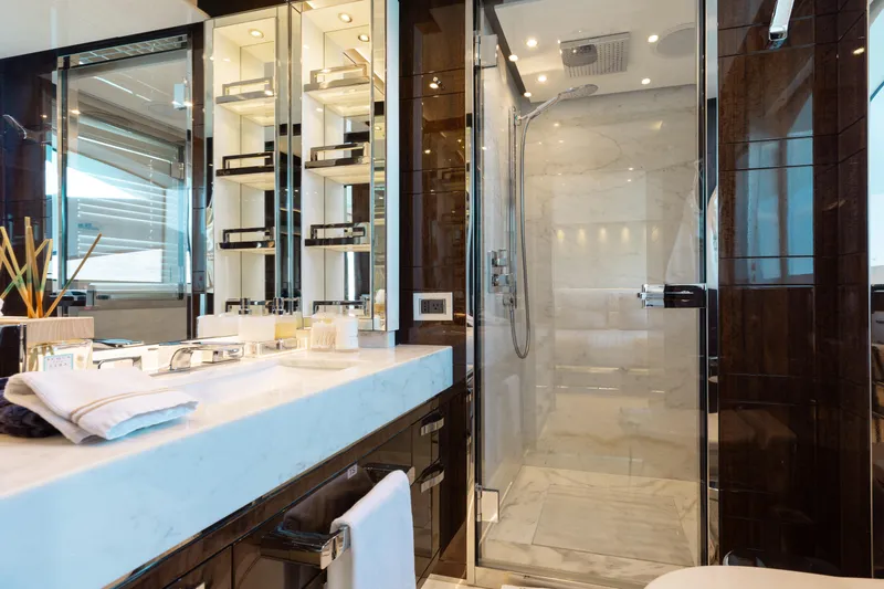 Domani Yacht Photos Pics Luxurious bathroom on 2016 Benetti Custom Built yacht with marble countertop and glass shower.
