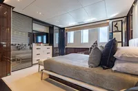 Luxurious bedroom interior on a 2016 Benetti Custom Built yacht, featuring modern design and elegant furnishings.
