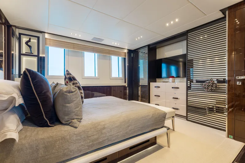 Domani Yacht Photos Pics Luxurious bedroom interior on 2016 Benetti Custom Built yacht, featuring modern design and elegant furnishings.