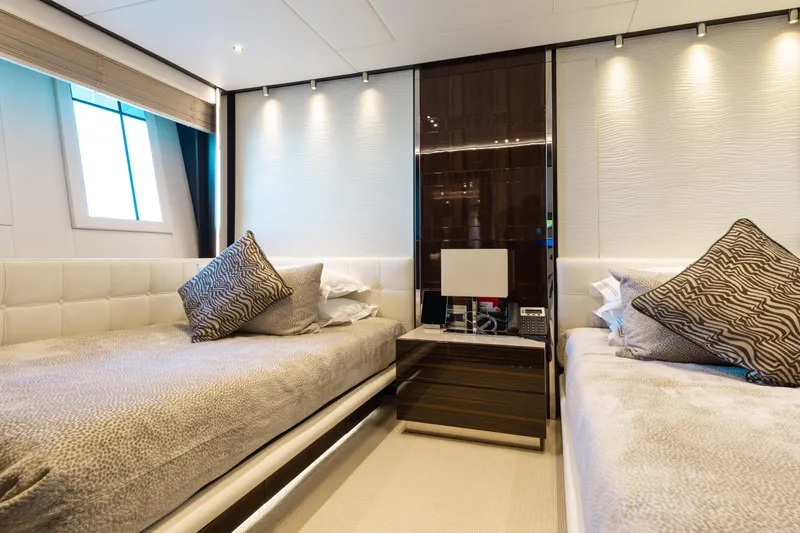 Domani Yacht Photos Pics Luxurious twin bedroom on 2016 Benetti Custom Built yacht, featuring elegant decor and ambient lighting.