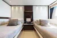 Luxurious twin bedroom on 2016 Benetti Custom Built yacht, featuring elegant decor and modern amenities.