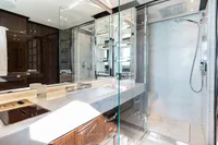 Luxurious bathroom in 2016 Benetti Custom Built yacht with modern fixtures and glass shower.