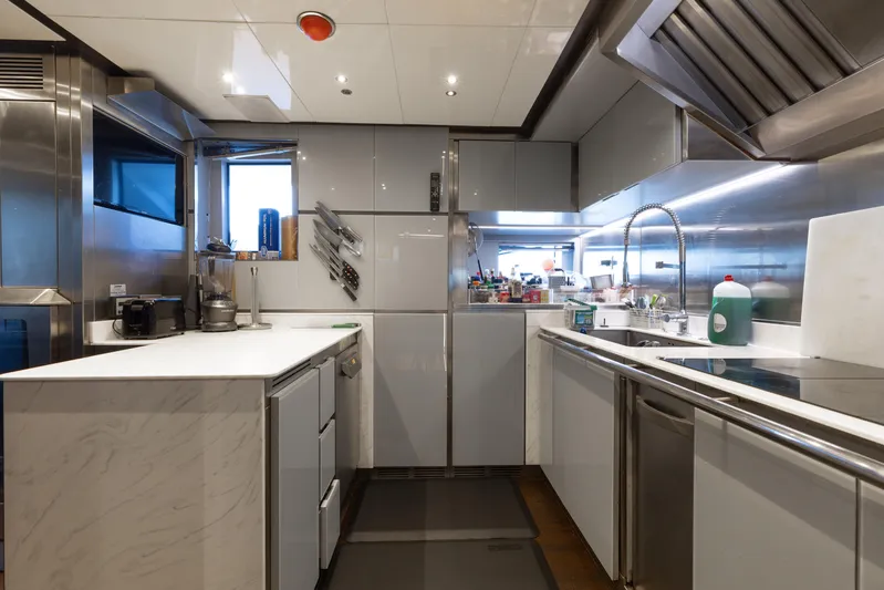 Domani Yacht Photos Pics Modern kitchen interior on 2016 Benetti Custom Built yacht, featuring sleek countertops and stainless steel appliances.