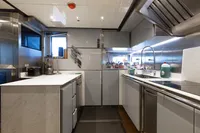Modern kitchen interior on 2016 Benetti Custom Built yacht, featuring sleek countertops and stainless steel appliances.