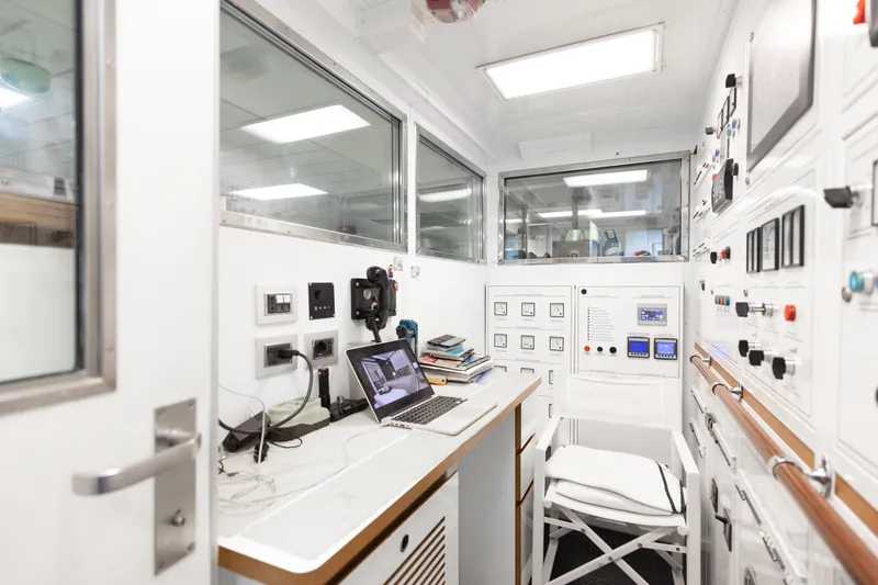 Domani Yacht Photos Pics Control room of a 2016 Benetti Custom Built yacht with modern equipment and laptop.