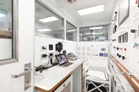 Control room of a 2016 Benetti Custom Built yacht with modern equipment and laptop.