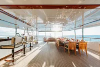 Luxurious 2016 Benetti Custom Built yacht with elegant dining area and ocean view.