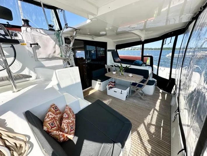 Never Say Never Yacht Photos Pics Luxurious 2017 Lagoon 42 catamaran interior with seating and ocean view.