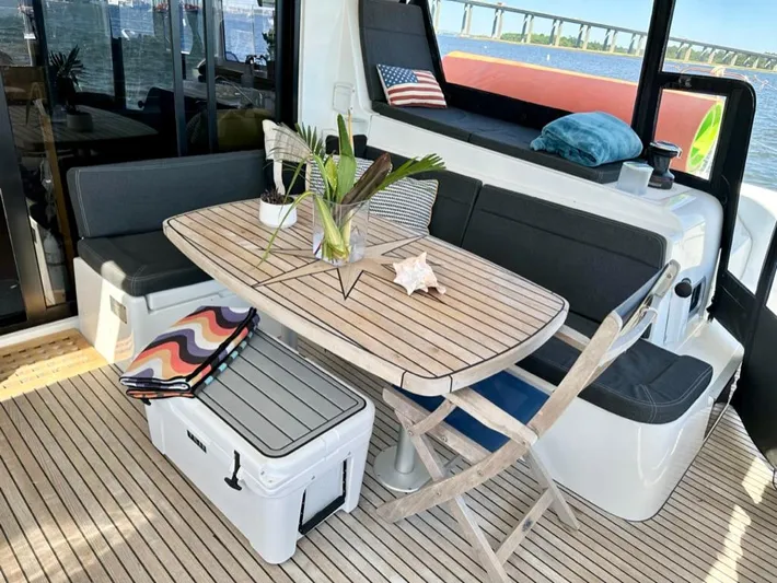 Never Say Never Yacht Photos Pics 2017 Lagoon 42 yacht interior with wooden table, seating, and nautical decor.