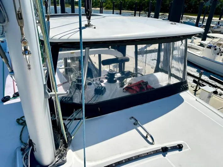 Never Say Never Yacht Photos Pics 2017 Lagoon 42 catamaran cockpit with clear enclosure and visible steering wheel.
