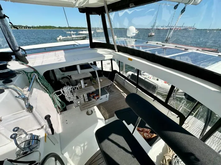 Never Say Never Yacht Photos Pics 2017 Lagoon 42 yacht cockpit with steering, ropes, and ocean view.