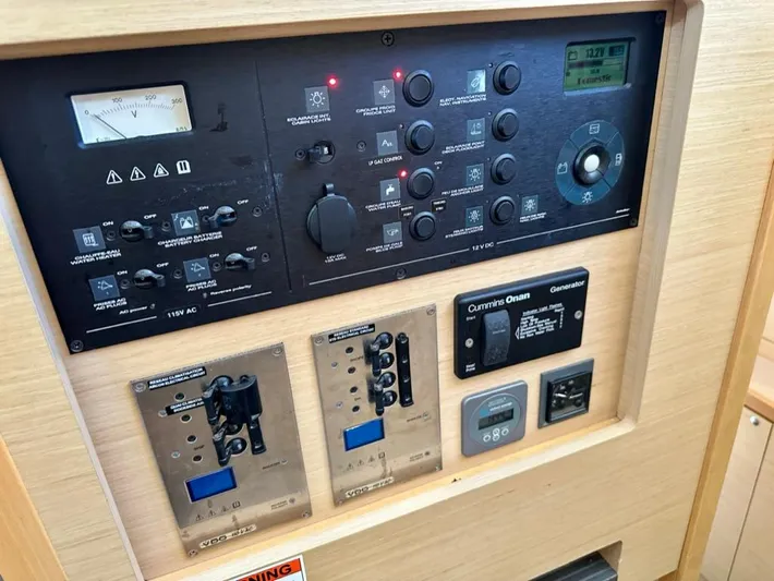 Never Say Never Yacht Photos Pics Control panel of a 2017 Lagoon 42 yacht, featuring various switches and gauges.