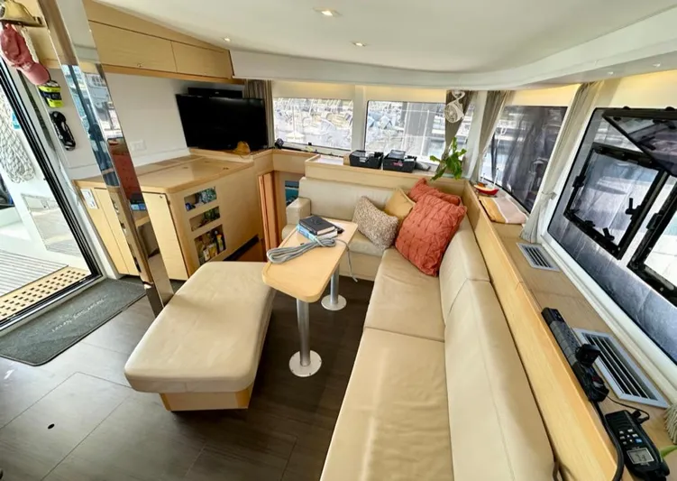 Never Say Never Yacht Photos Pics Interior of 2017 Lagoon 42 catamaran with modern seating and entertainment area.