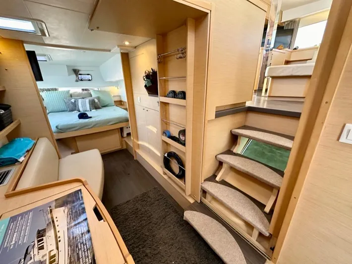Never Say Never Yacht Photos Pics Interior of 2017 Lagoon 42 catamaran featuring cozy bedroom, wooden stairs, and modern design elements.