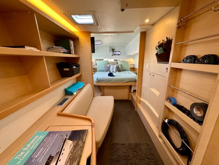 Never Say Never Yacht Photos Pics 2017 Lagoon 42 yacht interior with cozy cabin, shelves, and seating area.