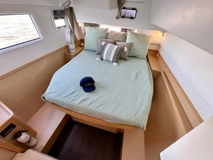 Never Say Never Yacht Photos Pics Cozy bedroom in 2017 Lagoon 42 catamaran with bed, pillows, and nautical decor.
