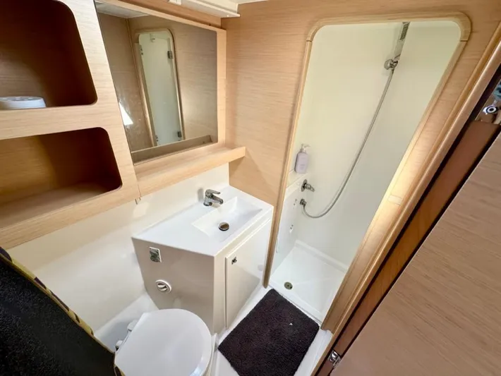 Never Say Never Yacht Photos Pics Modern bathroom in a 2017 Lagoon 42 yacht with shower, sink, and toilet.