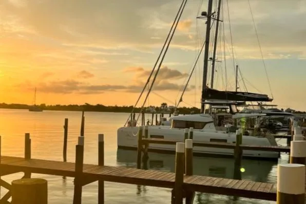 Never Say Never Yacht Photos Pics Lagoon 42 catamaran docked at sunset, serene waterfront view, 2017 model.