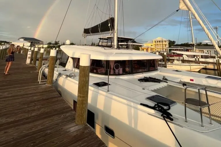 Never Say Never Yacht Photos Pics 2017 Lagoon 42 catamaran docked with rainbow in background.