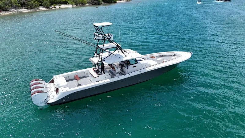  Yacht Photos Pics 2019 HCB 53 Sueños boat on clear blue water, featuring multiple outboard engines.