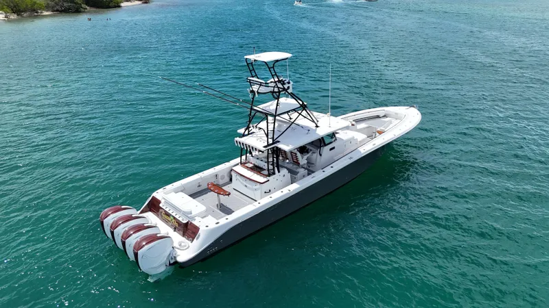  Yacht Photos Pics 2019 HCB 53 Sueños boat on clear blue water, featuring multiple outboard engines.