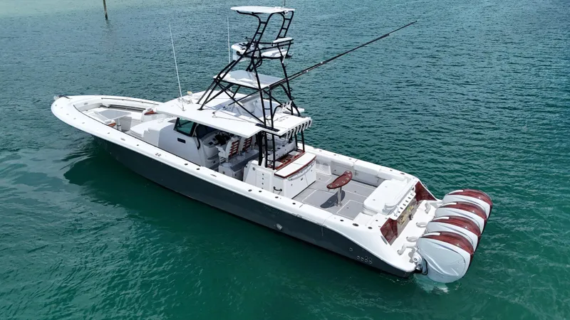  Yacht Photos Pics 2019 HCB 53 Sueños boat on clear turquoise water, featuring multiple outboard engines.