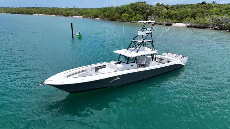  Yacht Photos Pics 2019 HCB 53 Sueños boat on turquoise water near lush shoreline.