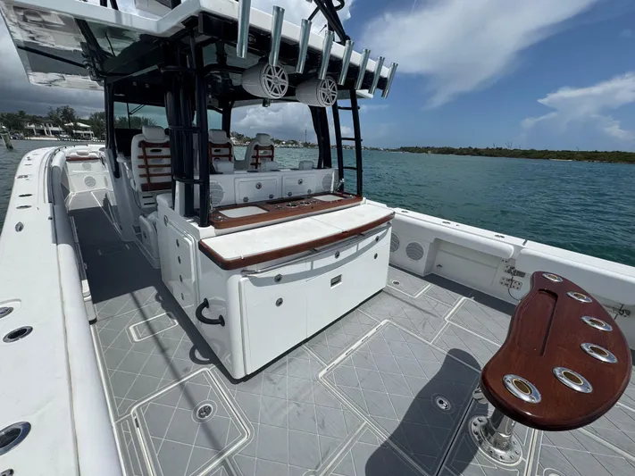  Yacht Photos Pics 2019 HCB 53 Sueños boat with spacious deck and seating, docked by the water.