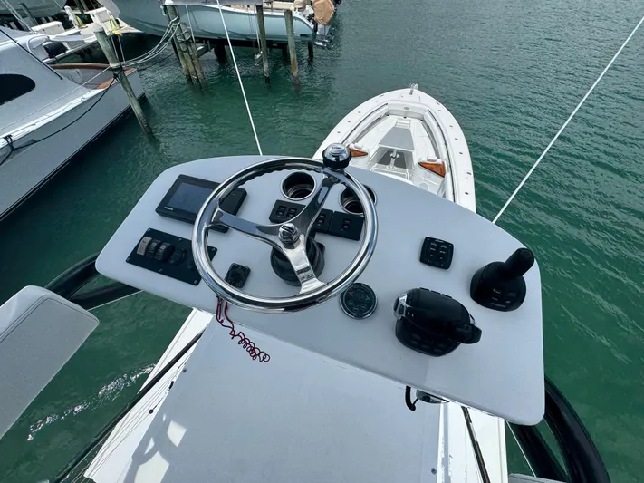  Yacht Photos Pics Helm of 2019 HCB 53 Sueños boat with steering wheel and controls.