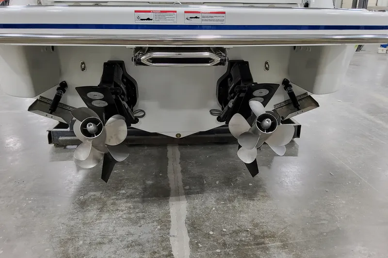  Yacht Photos Pics Rear view of 2026 Formula 310 Bowrider I/O with dual propellers in a showroom.