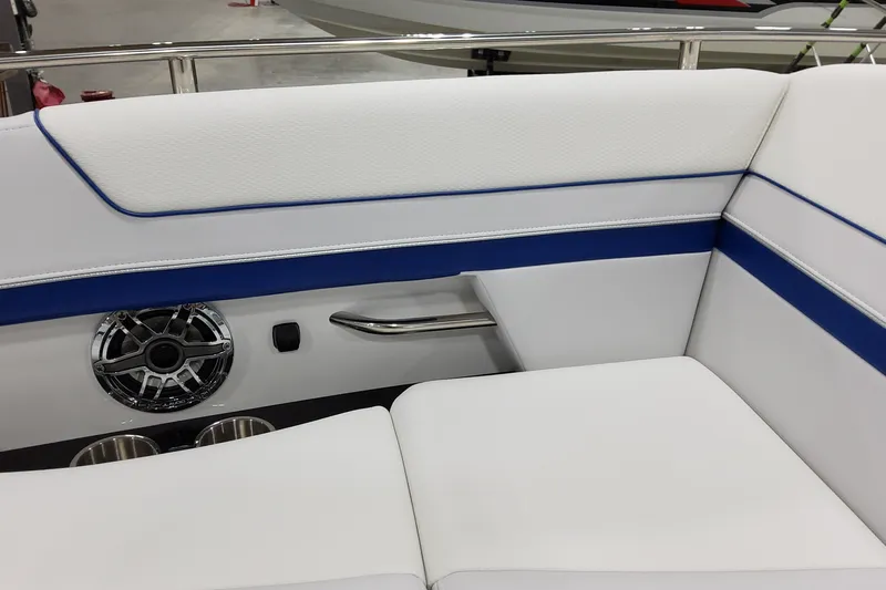  Yacht Photos Pics 2026 Formula 310 Bowrider I/O interior with white and blue seating, speaker, and cup holders.