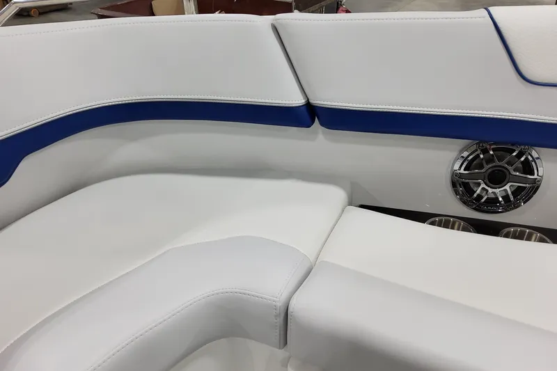  Yacht Photos Pics 2026 Formula 310 Bowrider I/O interior with white and blue seating, speaker, and cup holders.